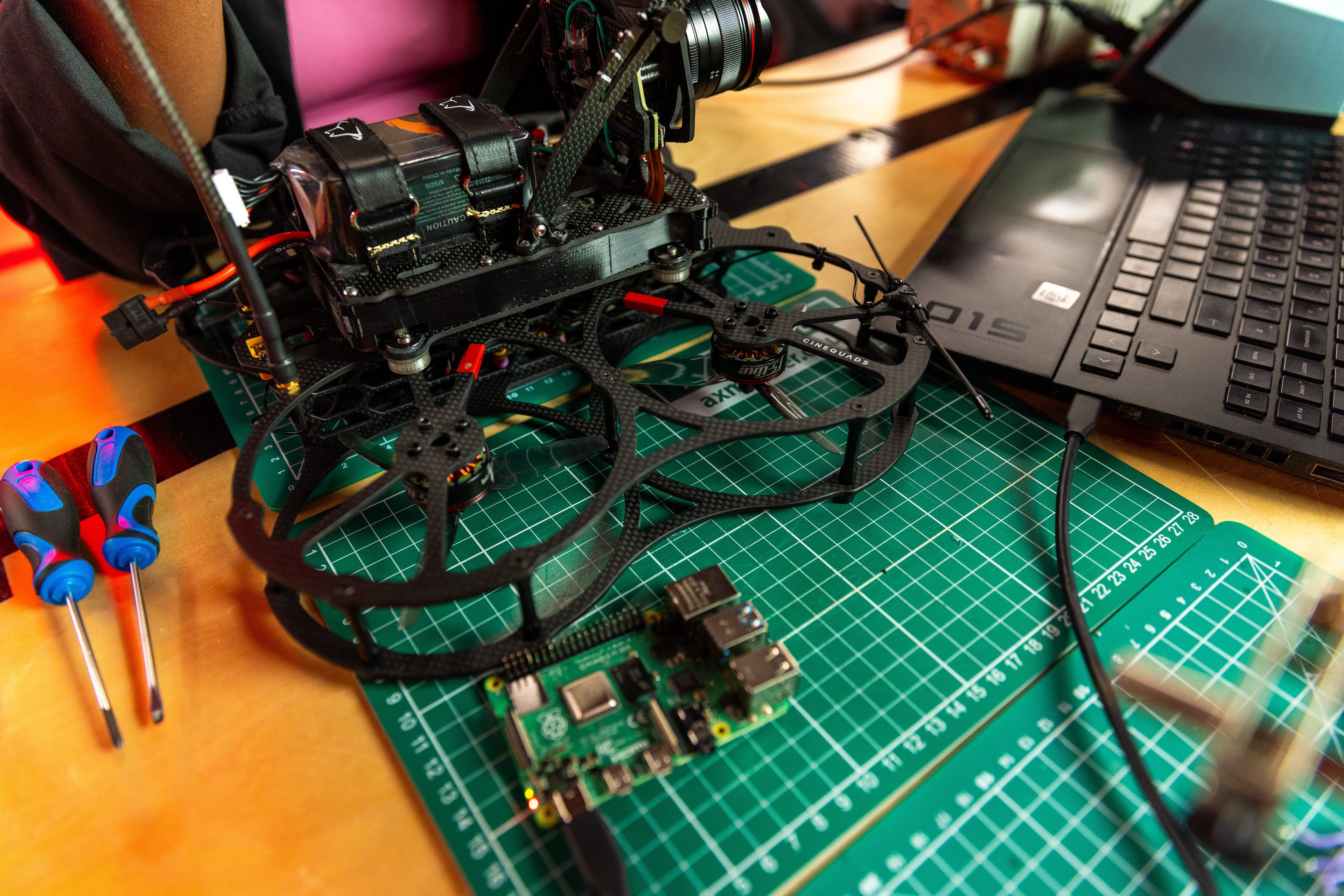 Engineer debugging firmware on embedded hardware with oscilloscope and logic analyser